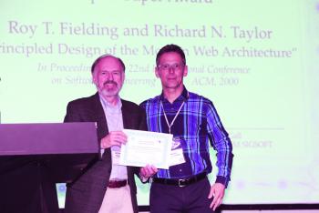 Taylor accepts Impact Paper award from SIGSOFT Chair Prof. Medvidović.